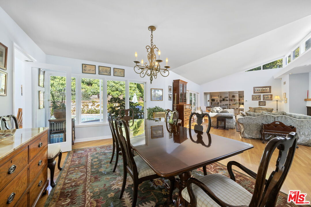 11215 Sunset Boulevard Los Angeles, CA 90049 - Photo 24 of 74 a view of a dining room with furniture and chandelier