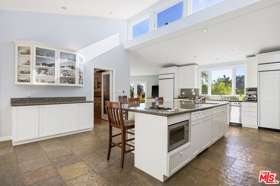 11215 Sunset Boulevard Los Angeles, CA 90049 - Photo 26 of 74 a kitchen with appliances a sink and cabinets