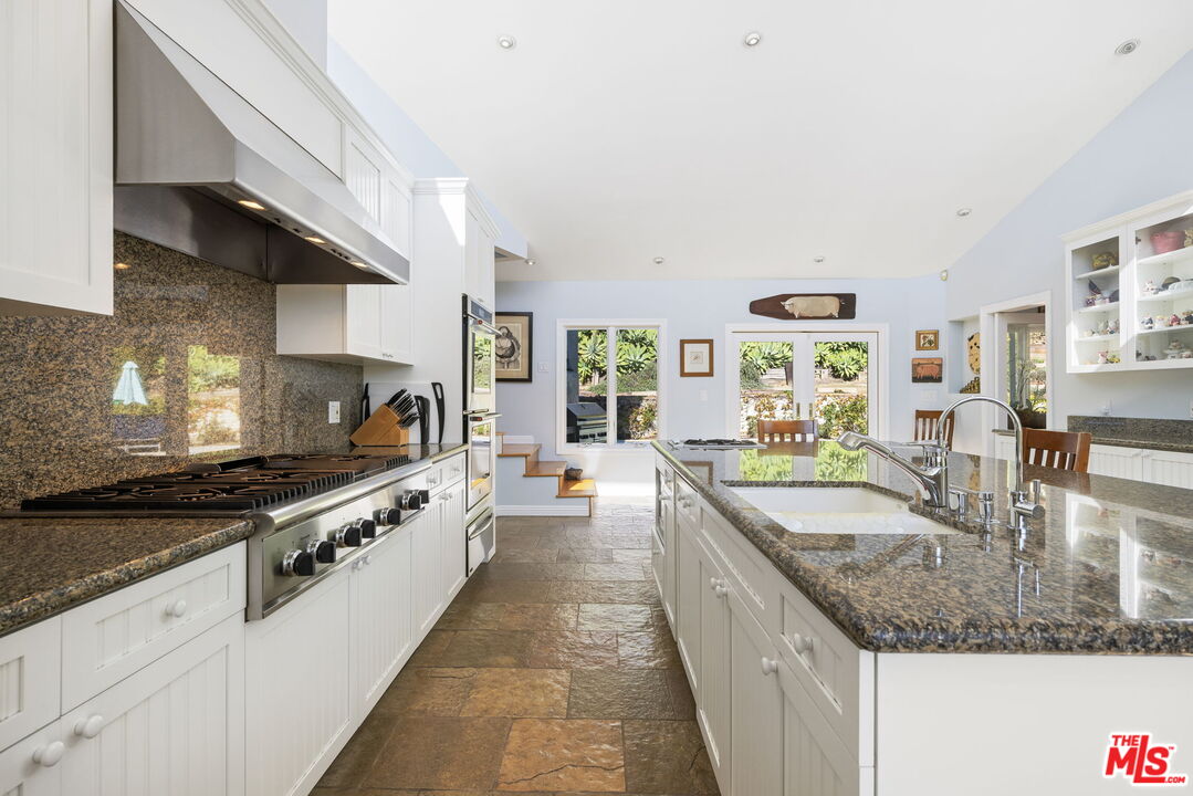 11215 Sunset Boulevard Los Angeles, CA 90049 - Photo 29 of 74 a large kitchen with stainless steel appliances granite countertop a lot of counter space and a sink