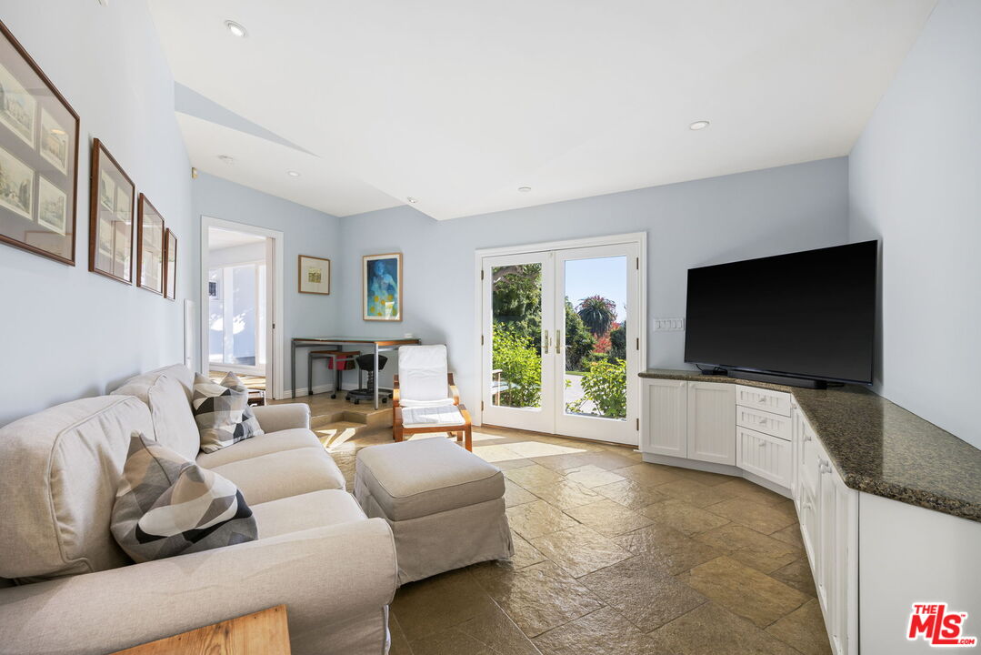 11215 Sunset Boulevard Los Angeles, CA 90049 - Photo 31 of 74 a living room with furniture and a flat screen tv