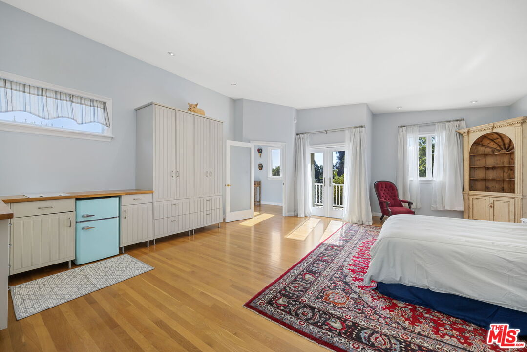 11215 Sunset Boulevard Los Angeles, CA 90049 - Photo 35 of 74 a spacious bedroom with a large bed and a dresser