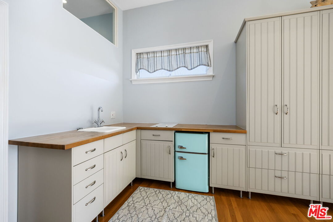 11215 Sunset Boulevard Los Angeles, CA 90049 - Photo 36 of 74 a kitchen with granite countertop white cabinets and sink