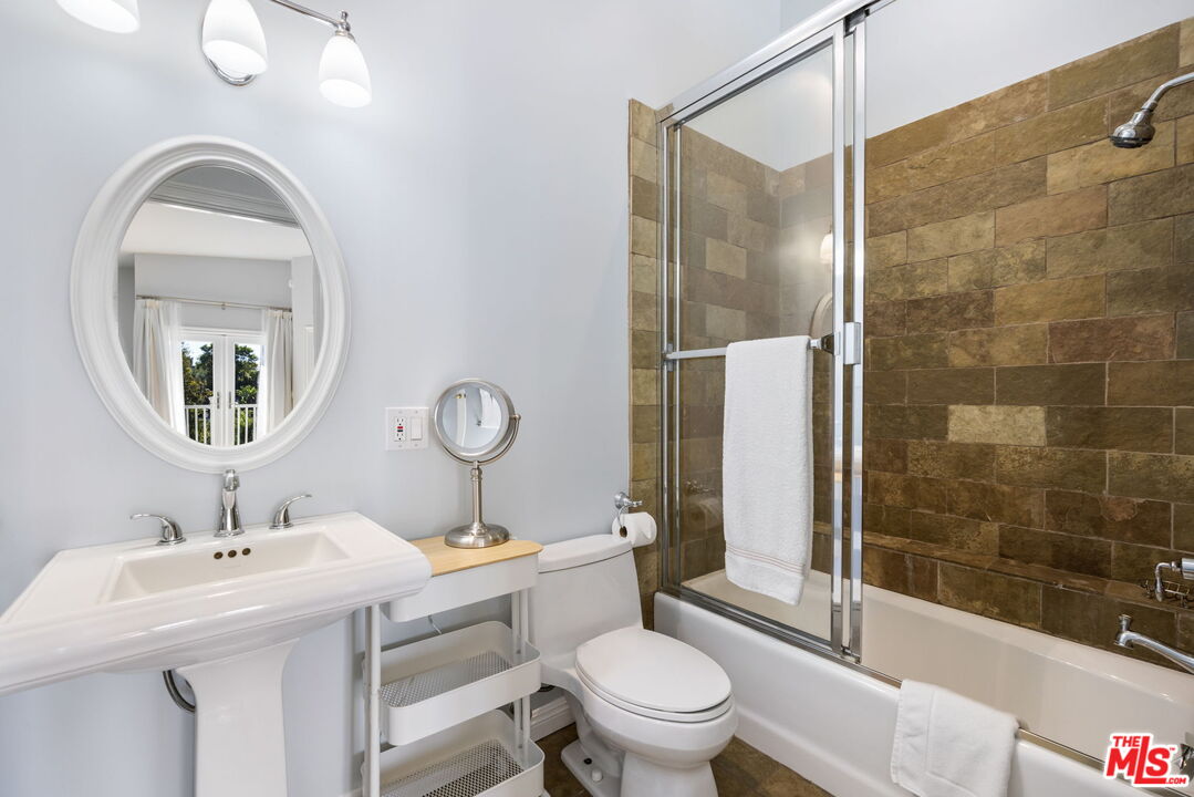 11215 Sunset Boulevard Los Angeles, CA 90049 - Photo 37 of 74 a bathroom with a sink toilet and shower