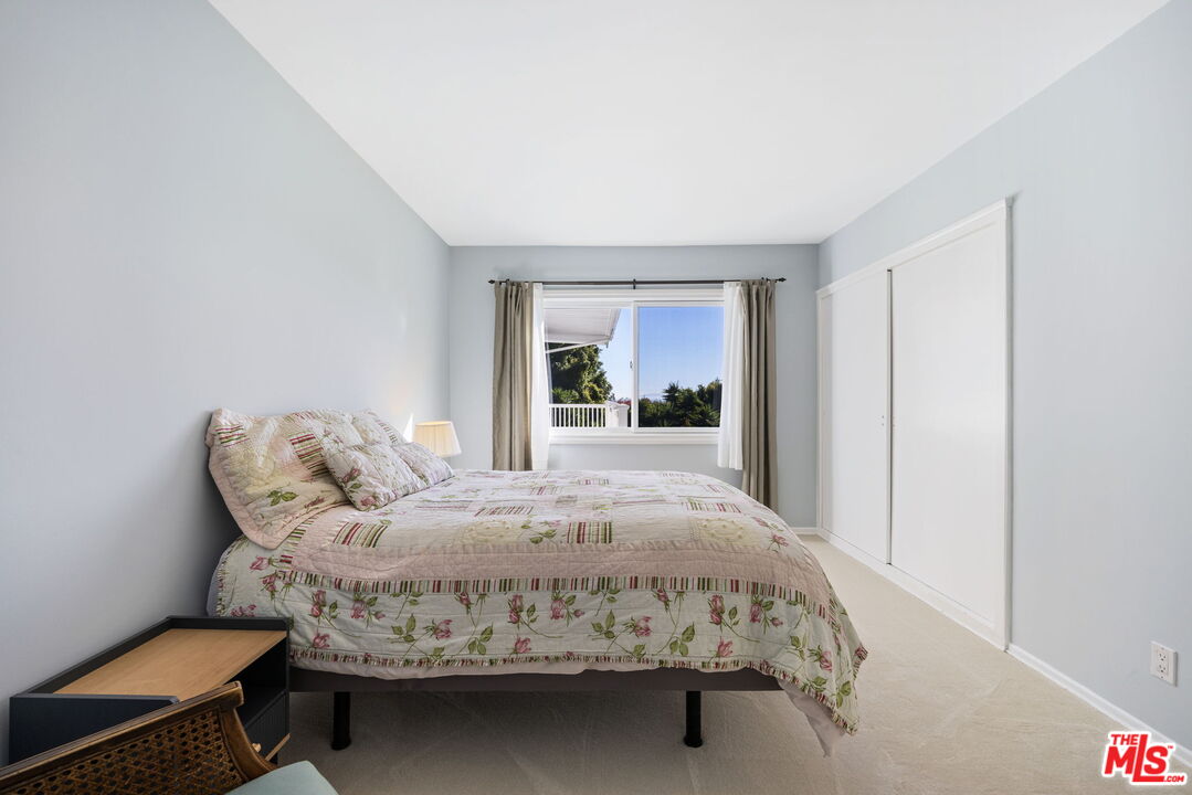 11215 Sunset Boulevard Los Angeles, CA 90049 - Photo 52 of 74 a bed sitting in a spacious bedroom next to a window