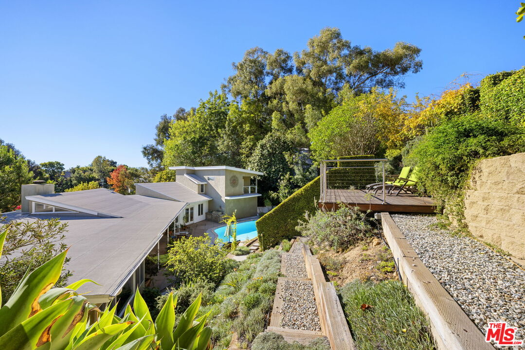 11215 Sunset Boulevard Los Angeles, CA 90049 - Photo 60 of 74 a view of a yard with plants and a bench