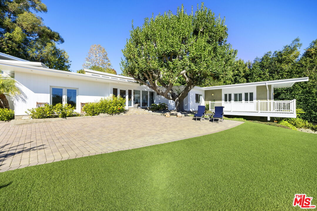 11215 Sunset Boulevard Los Angeles, CA 90049 - Photo 6 of 74 a front view of a house with a yard