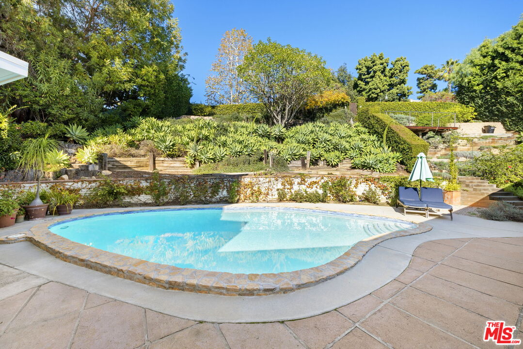 11215 Sunset Boulevard Los Angeles, CA 90049 - Photo 63 of 74 a view of a swimming pool with a yard