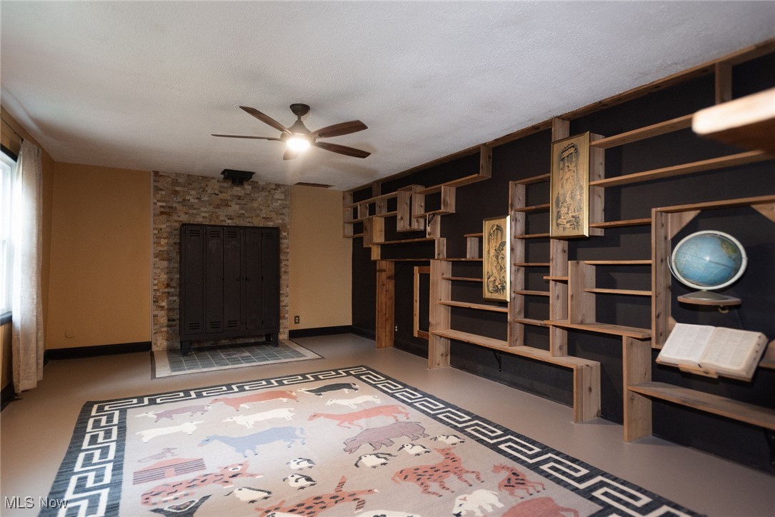 7342 Peck Road Ravenna, OH 44266 - Photo 7 of 20 Unfurnished living room with a ceiling fan and a textured ceiling