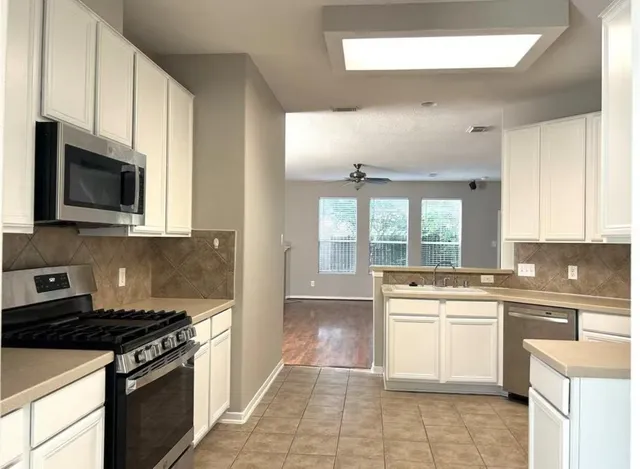 a kitchen with a stove top oven sink and cabinets
