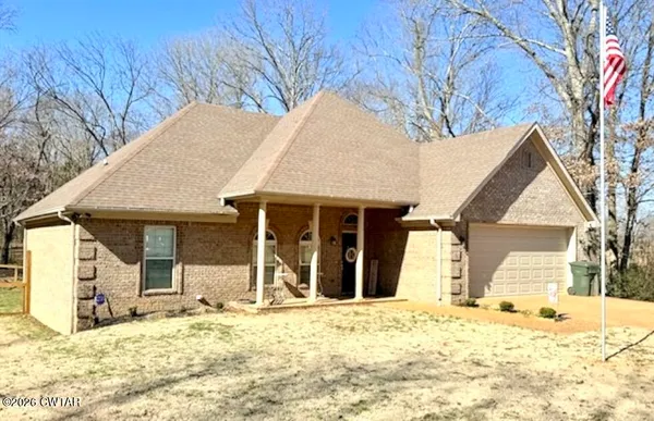 a view of a house with snow on the background