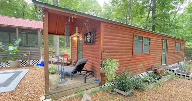 a view of a patio with table and chairs potted plants with wooden fence