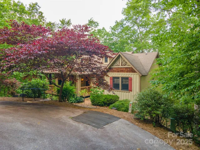 a view of a house with a tree and plants