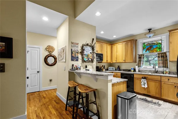 a kitchen with a sink appliances cabinets and furniture