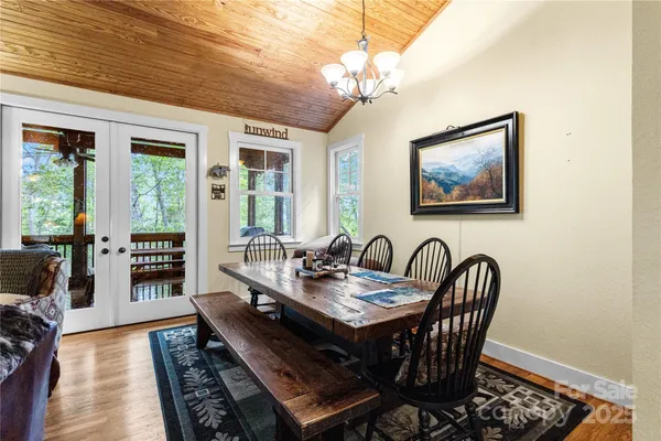 a dining room with furniture a rug and wooden floor