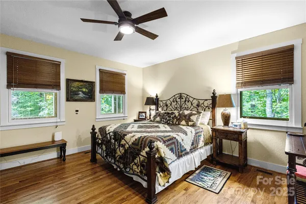 a bedroom with a bed and a large window