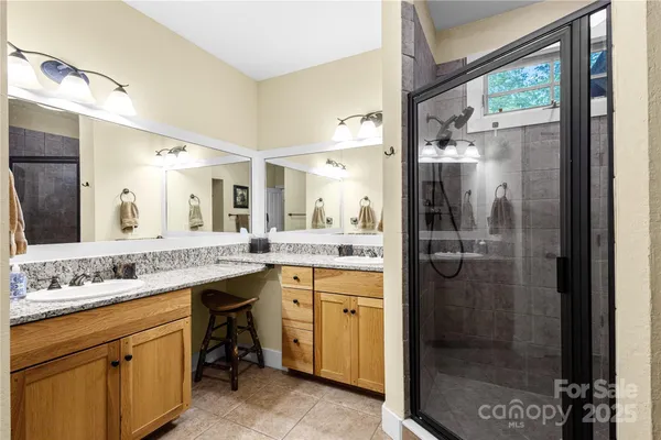 a bathroom with a shower sink and mirror