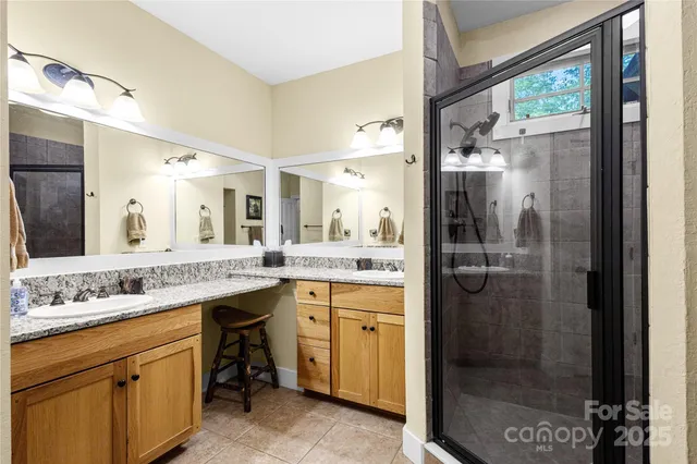 a bathroom with a shower sink and mirror