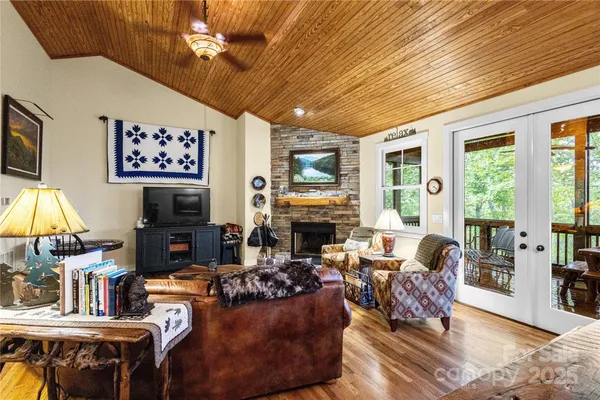 a living room with fireplace furniture and a flat screen tv