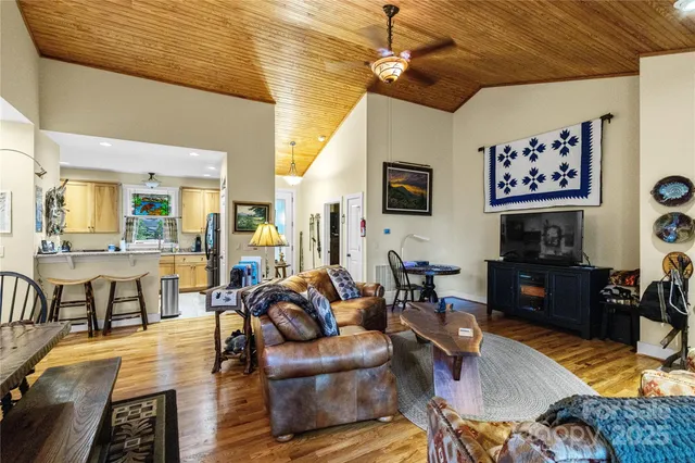 a living room with furniture kitchen view and a fireplace
