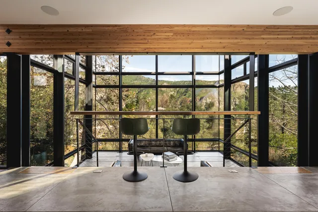 a living room with furniture and a floor to ceiling window