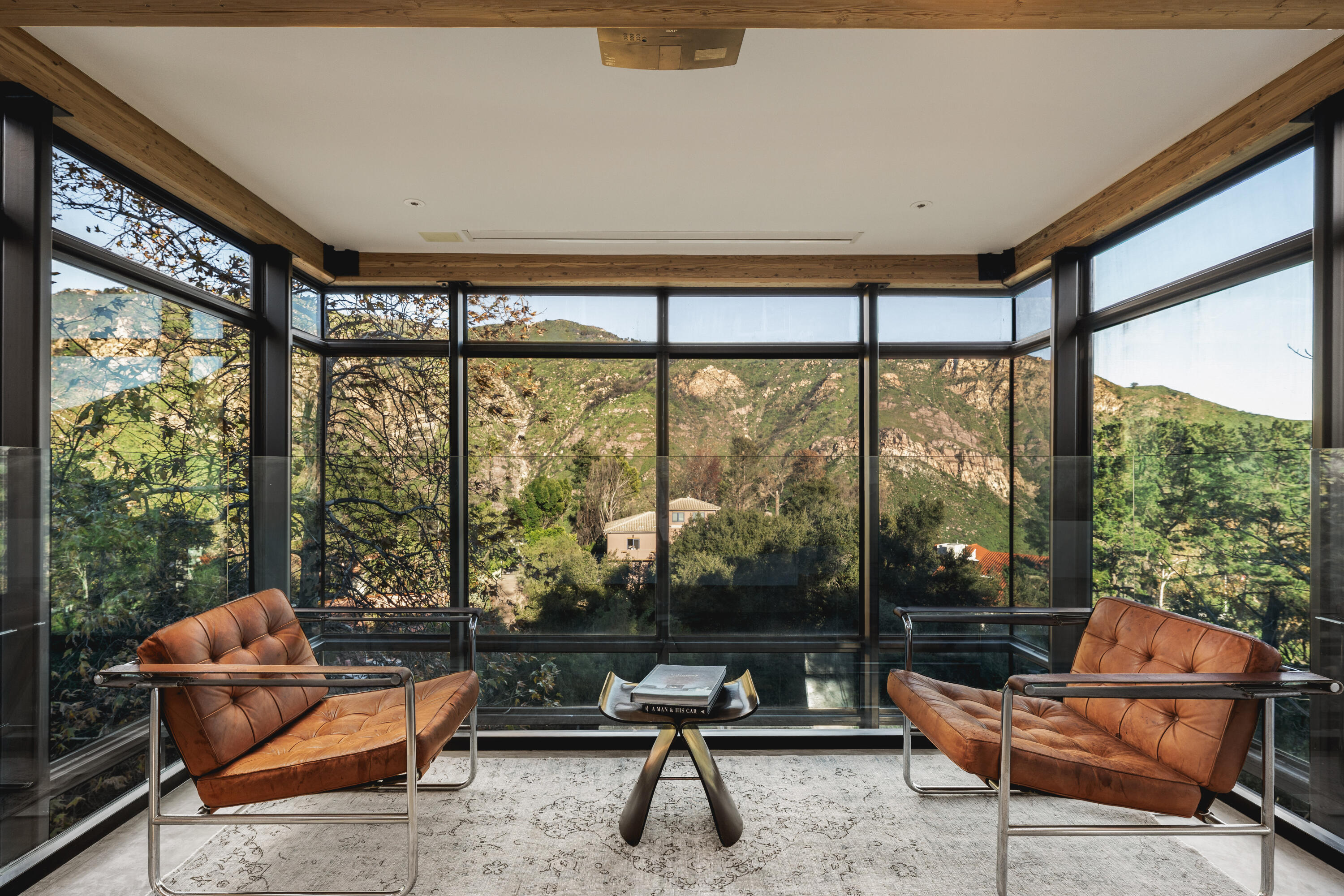 2315 Live Oak Meadows Road Malibu, CA 90265 - Photo 19 of 32 a living room with furniture and a floor to ceiling window