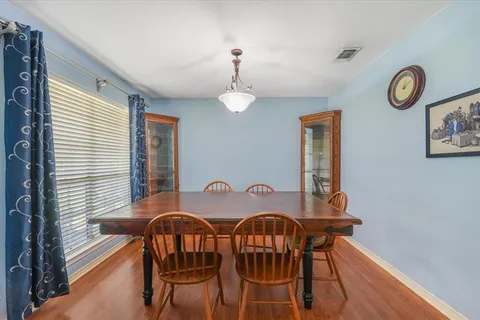a view of a dining room with furniture and a window