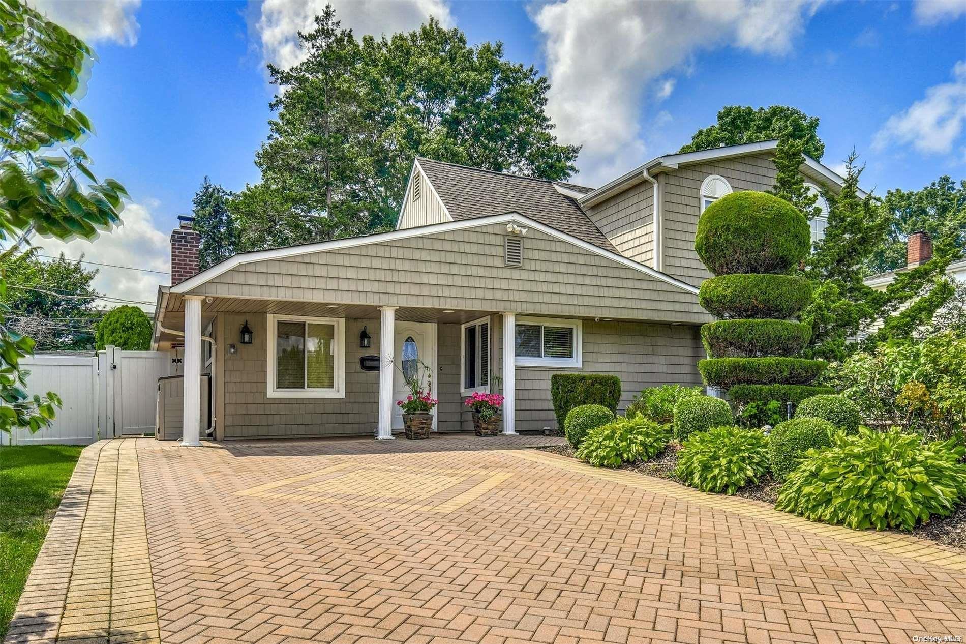 a front view of a house with a garden