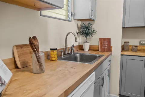a kitchen with a sink and a stove top oven