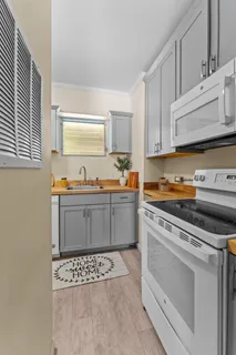 a kitchen with stainless steel appliances a stove a sink and a microwave