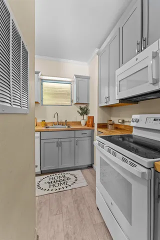 a kitchen with stainless steel appliances a stove a sink and a microwave