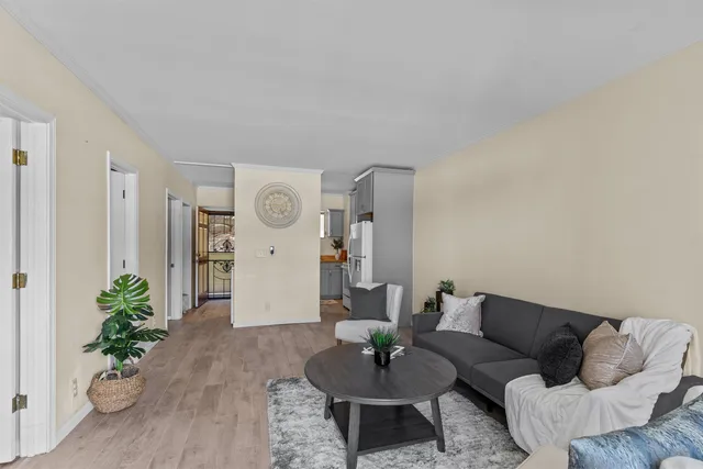 a living room with furniture and wooden floor