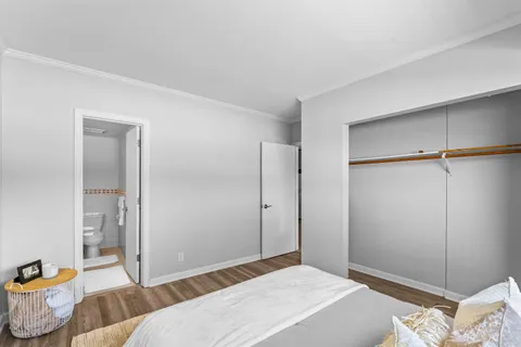 a bedroom with a bed and a couch