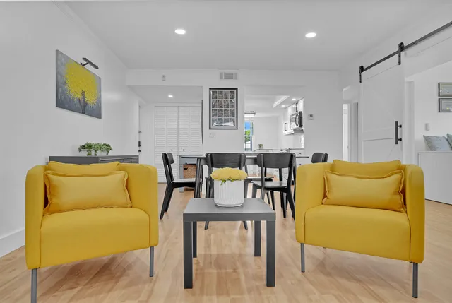 a living room with furniture and painting on the wall