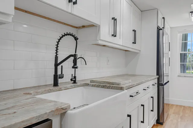 a kitchen with a sink and cabinets