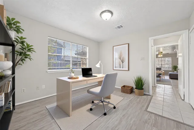 a workspace with furniture window and wooden floor