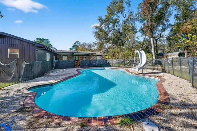 a view of a swimming pool with an outdoor seating