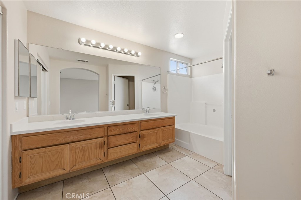 250 Settlers Road Upland, CA 91786 - Photo 19 of 31 a spacious bathroom with a double vanity sink a mirror and a bathtub