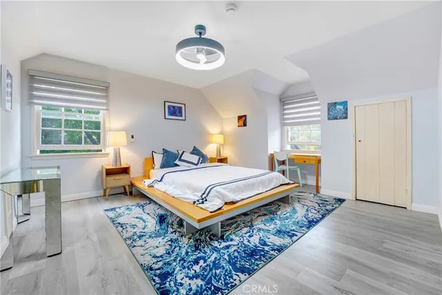 a bedroom with a bed a mirror and a window