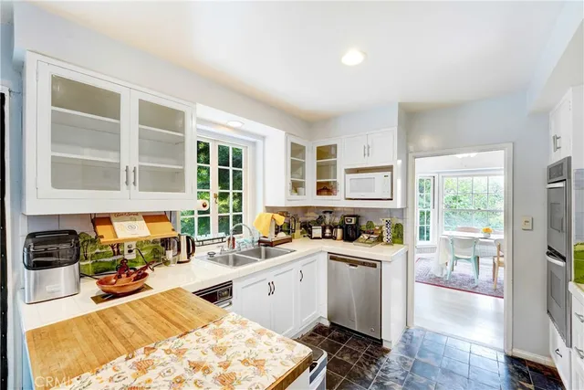 a kitchen with a sink stove and wooden cabinets