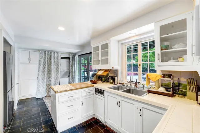 a kitchen that has a sink and a large window