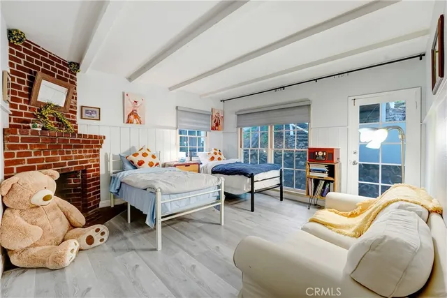 a bedroom with furniture and a wooden floor