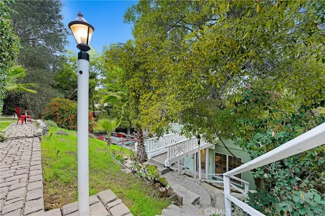 a front view of a house with a yard and mountain view