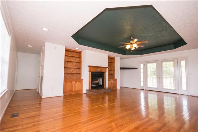 2153 Liebengood Road Goodlettsville, TN 37072 - Photo 2 of 20 A large, open living room invites you inside. There is hardwood flooring, built-in bookshelves, tray ceiling, fireplace w/gas logs....