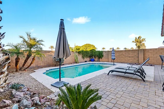 a view of a patio with a table and chairs