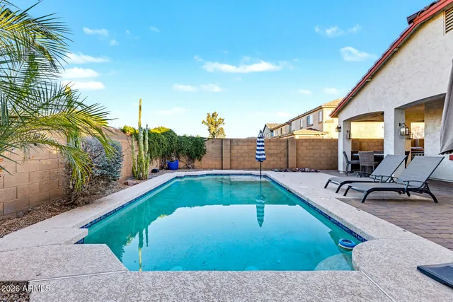 a swimming pool with outdoor seating and yard