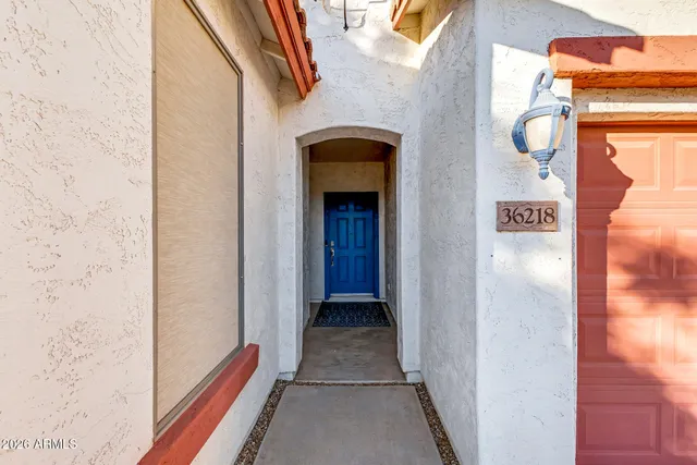 a view of a hallway with wooden floor and entryway