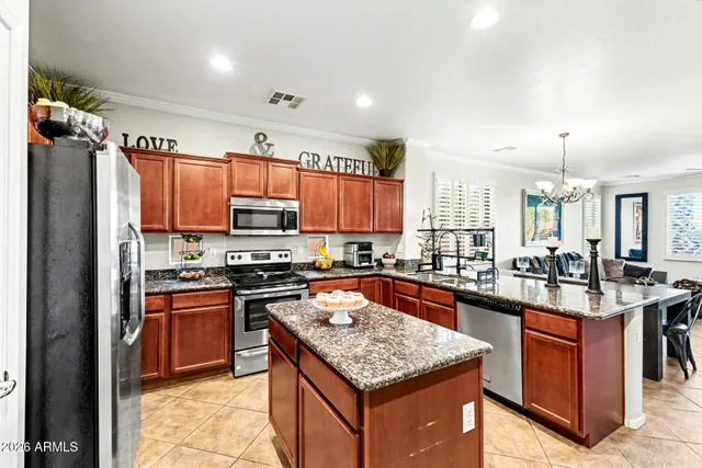 a kitchen with stainless steel appliances granite countertop granite counter tops refrigerator a stove top oven and a sink