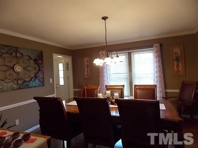 7316 Massachusetts Court Raleigh, NC 27615 - Photo 11 of 16 a view of a dining room with furniture window and outside view