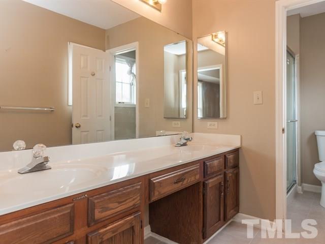 7316 Massachusetts Court Raleigh, NC 27615 - Photo 15 of 16 a bathroom with a sink and a mirror