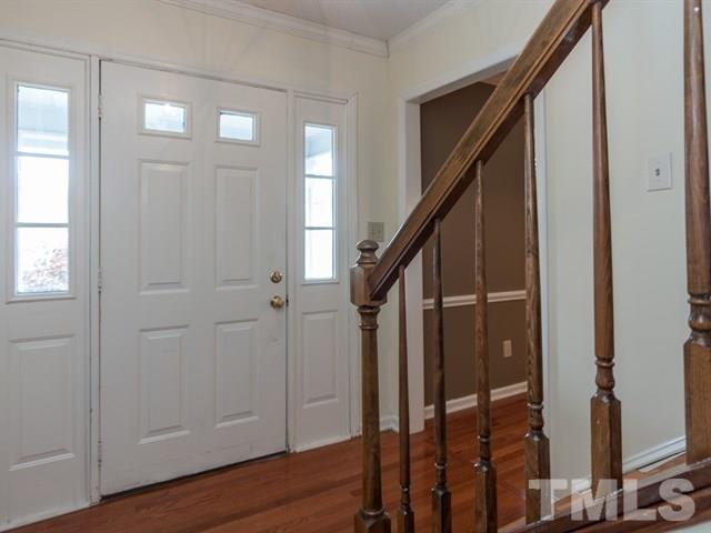 7316 Massachusetts Court Raleigh, NC 27615 - Photo 3 of 16 a view of entryway with wooden floor and stairs